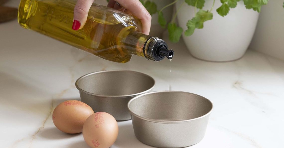  Adding 1 teaspoon of oil each to 2 ramekins 