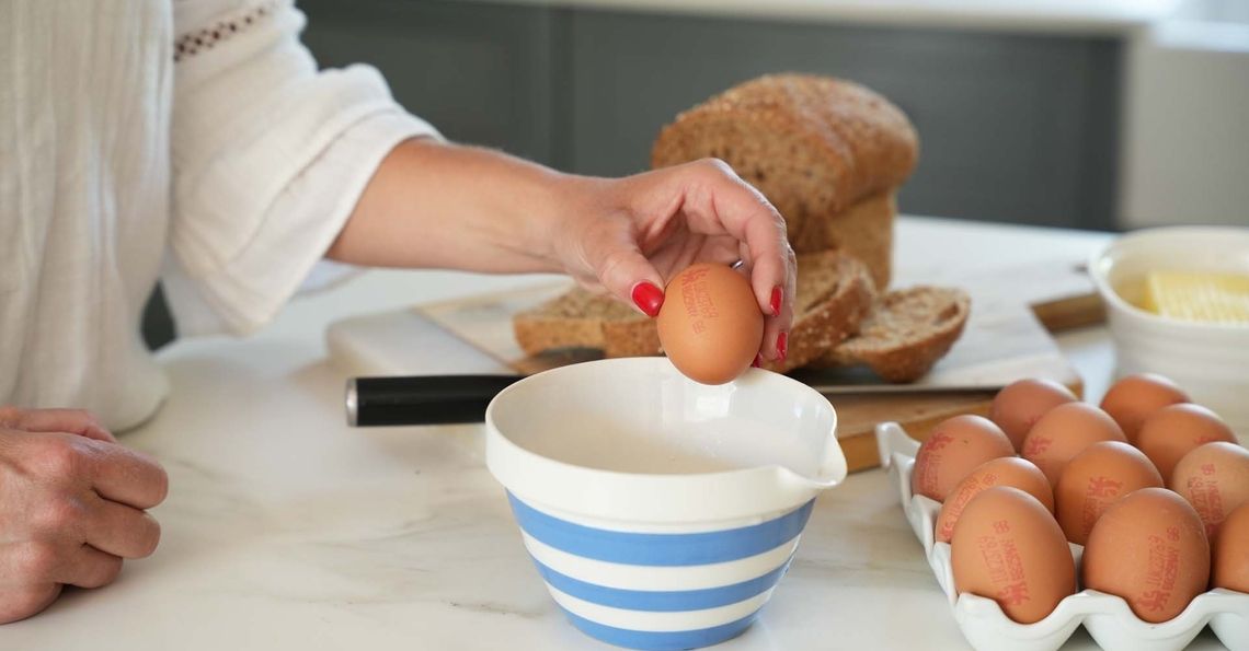 Cracking eggs into bowl